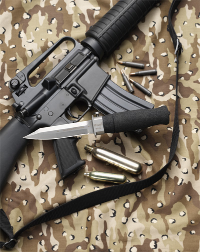 The replaceable cartridges are pictured next to the WASP Injection Knife. Gun not included. (Image via WASPKnife.com)